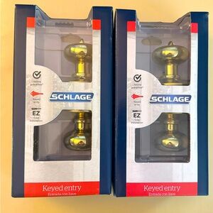 Two Schlage Bright Brass Doorknob - keyed entry. Never used & in original box.